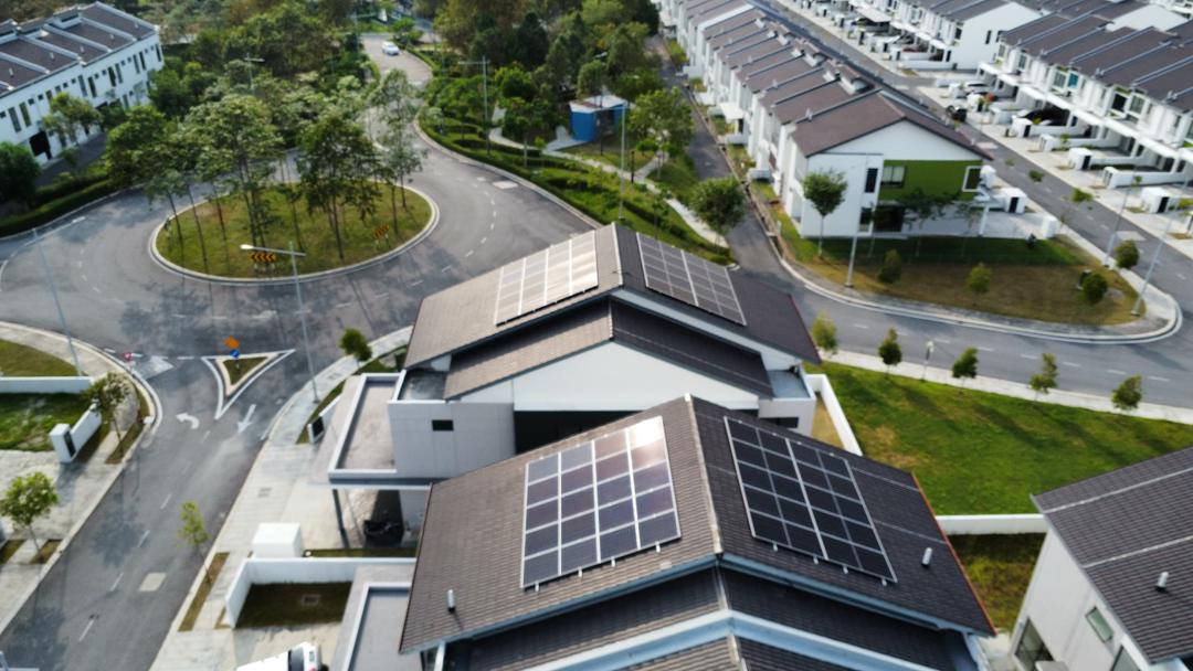 Solar panels installed across a modern bungalow roof in Malaysia